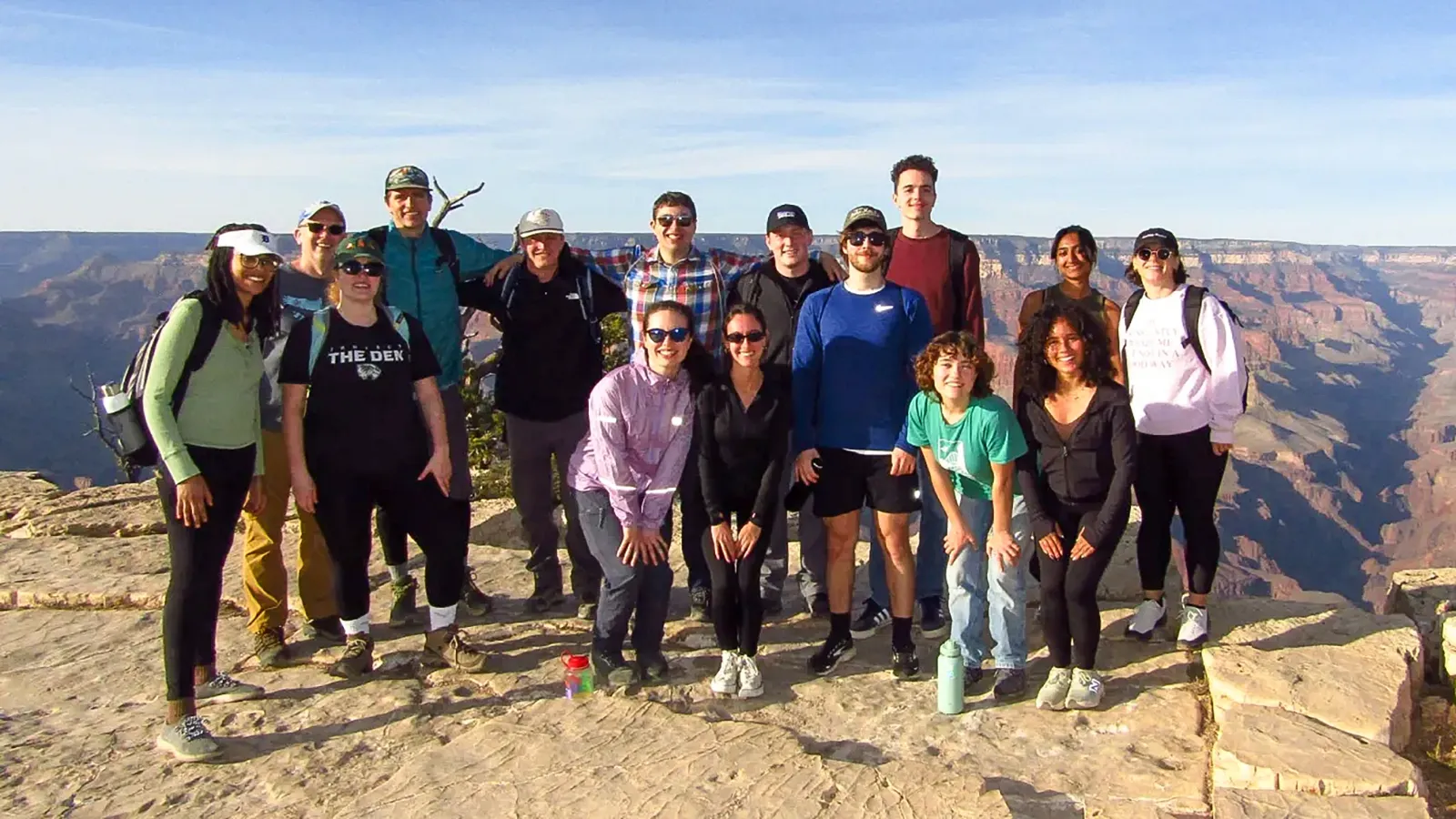 A group of students standing in front of the Grand Canyon