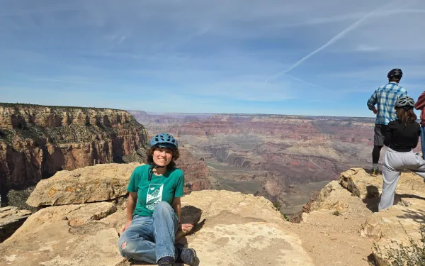 Student sitting on the edge of the Grand Canyon