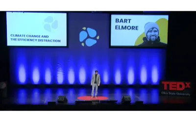 Bart Elmore standing center stage at TEDx presenting