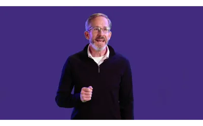 Kip Curtis presenting in front of a purple background