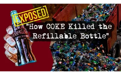 A hand holding a glass bottle of Coca-Cola and a dump truck full of recyclable plastic bottles