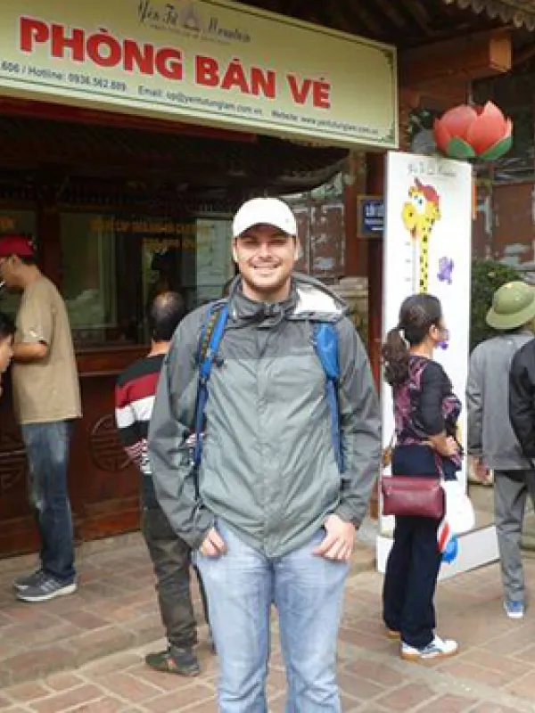 Michael corsi standing in front of the ticket counter at  Yên Tử Mountain historical and scenic site in Quảng Ninh, Vietnam