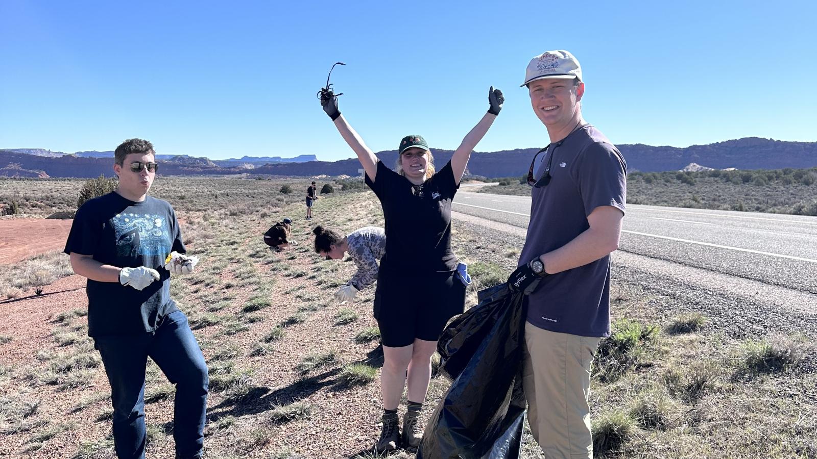 students collecting trash on the side of a highway in Utah